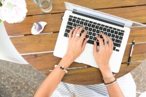 business woman typing on computer for conversational copywriting for SEO