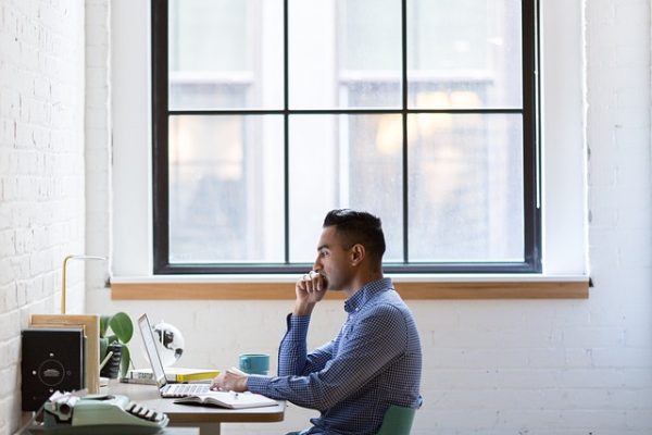 Man sitting at desk researching keywords for SEO